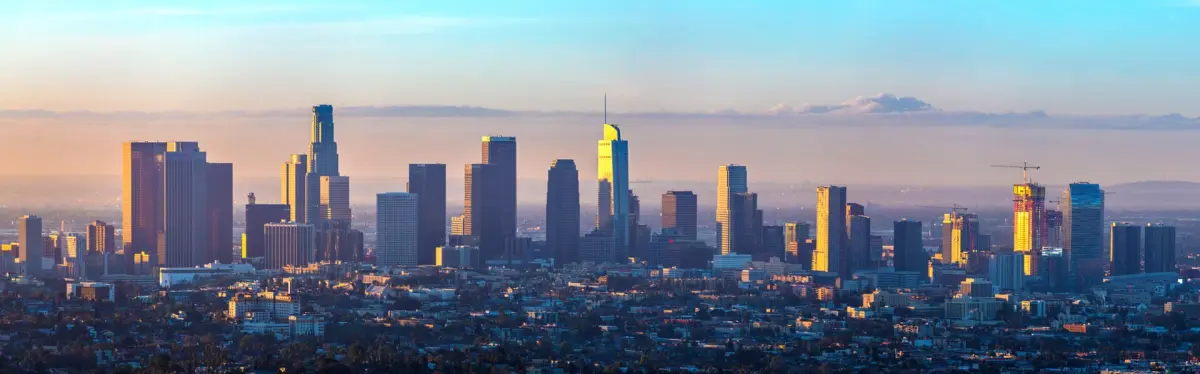Downtown Los Angeles towers against a golden sky
